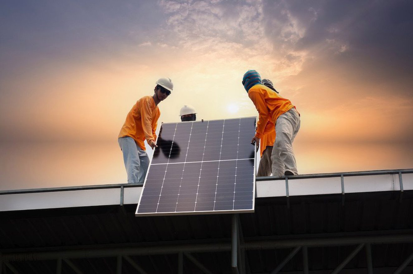 worker-installs-solar-panels-farm-field